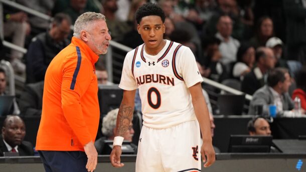 Tahaad Pettiford listens to coach Bruce Pearl during an Auburn game.