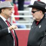 Oklahoma athletic director Joe Castiglione talks with Jim Ross before a game.