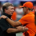 Dabo Swinney and Kirby Smart shake hands.