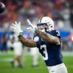 Penn State wide receiver Julian Fleming catches a pass in warmups.