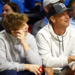 Lane Kiffin and his son, Knox, at a basketball game.