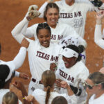 Texas A&M softball players celebrate.