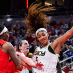 Angel Reese gets fouled by Caitlin Clark.
