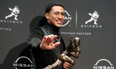 Bryce Young poses with his Heisman Trophy.