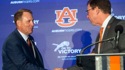 Hugh Freeze and John Cohen at a press conference.