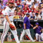 Arkansas pitcher Zach Root walks off the field.