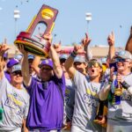 Jay Johnson hoists NCAA trophy after LSU wins national championship.