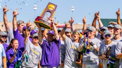Jay Johnson hoists NCAA trophy after LSU wins national championship.