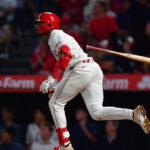 Christian Moore reacts to a home run.