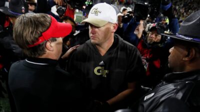 Georgia Tech head coach Brent Key shakes hands with Georgia head coach Kirby Smart.
