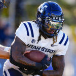 Rahsul Faison carries the ball.