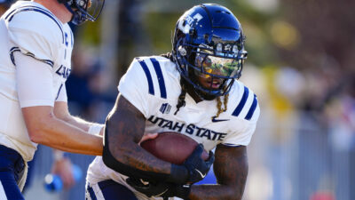 Rahsul Faison carries the ball.