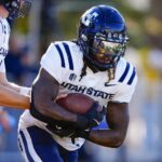 Running back Rahsul Faison carries the ball.