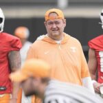 Josh Heupel stands next to Jake Merklinger and Joey Aguilar.