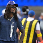 CeeDee Lamb in street clothes during an NFL preseason game.