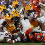 LSU and Clemson players battle.