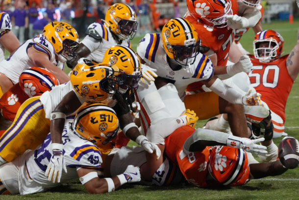 LSU and Clemson players battle.