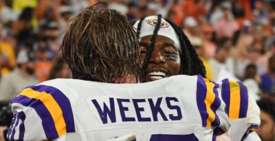 LSU defenders Harold Perkins Jr. and Whit Weeks hug.