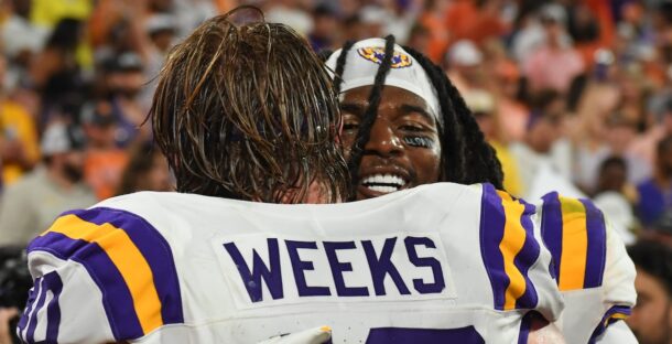 LSU defenders Harold Perkins Jr. and Whit Weeks hug.