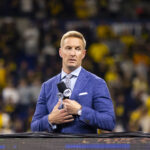 Joel Klatt sits at a game.