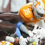 Tennessee player tackles a Mississippi State player.