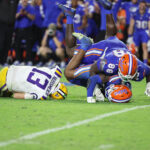 Florida players tackle Garrett Nussmeier.