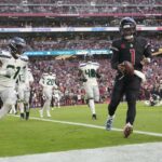 Kyler Murray runs the ball into the end zone.