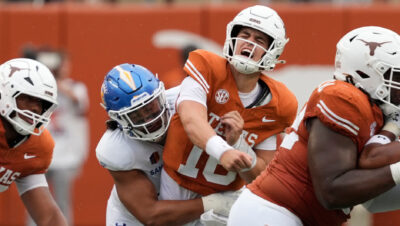 Texas quarterback Arch Manning gets hit.