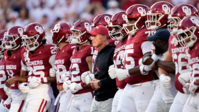 Oklahoma football players and coach Brent Venables before a game.