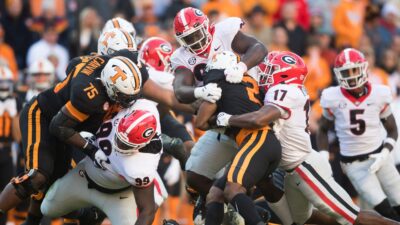 Tennessee and Georgia players play football.