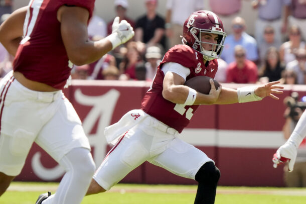 Ty Simpson runs with the ball.