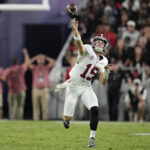 Ty Simpson attempts a pass.