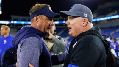 Hugh Freeze and Mark Stoops meet after a game.