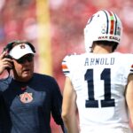 Auburn coach Hugh Freeze speaks with quarterback Jackson Arnold.