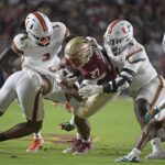 Miami's defense swallows up a Florida State player.
