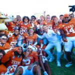 Texas players and coaches celebrate a rivalry win over Oklahoma.
