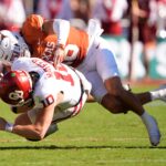 John Mateer gets tackled by Texas.