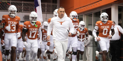 Steve Sarkisian leads the Texas Longhorns out of the tunnel.