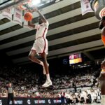 Charles Bediako dunks the ball.