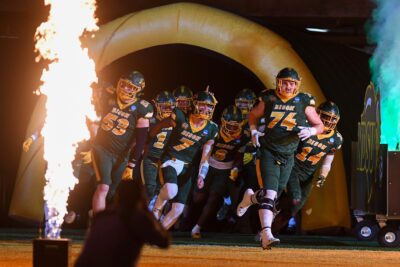 North Dakota State Football players run on the field.