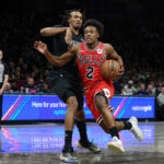 Collin Sexton drives the ball.