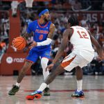 Florida Gators guard Boogie Fland looks to pass the ball against Texas Longhorns guard Tramon Mark