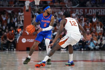 Florida Gators guard Boogie Fland looks to pass the ball against Texas Longhorns guard Tramon Mark