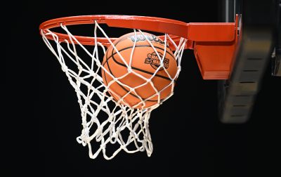 A basketball going through a net.