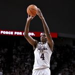 Jamie Vinson (4) attempts a three point basket during the second half against the Texas Longhorns