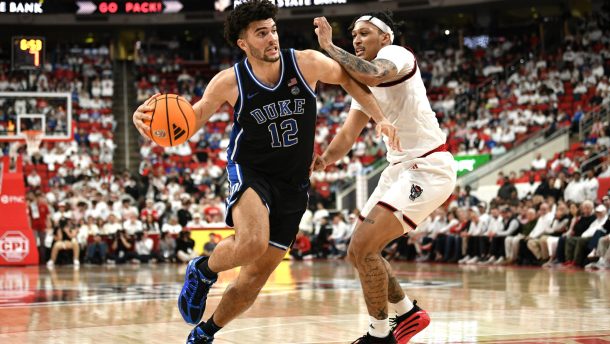 Cameron Boozer drives the ball around NC State Wolfpack forward Darrion Williams.