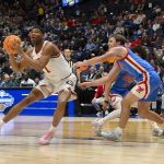 Kareem Stagg drives to the basket past Mississippi Rebels guard Travis Perry.
