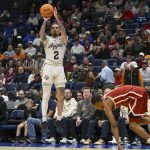 Pop Isaacs (2)shoots a three point basket against the Oklahoma Sooners.