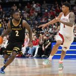 Duke Miles dribbles the ball defended by Arkansas Razorbacks guard Meleek Thomas.