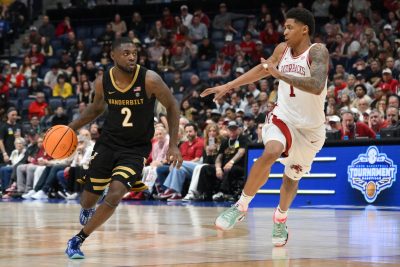 Duke Miles dribbles the ball defended by Arkansas Razorbacks guard Meleek Thomas.